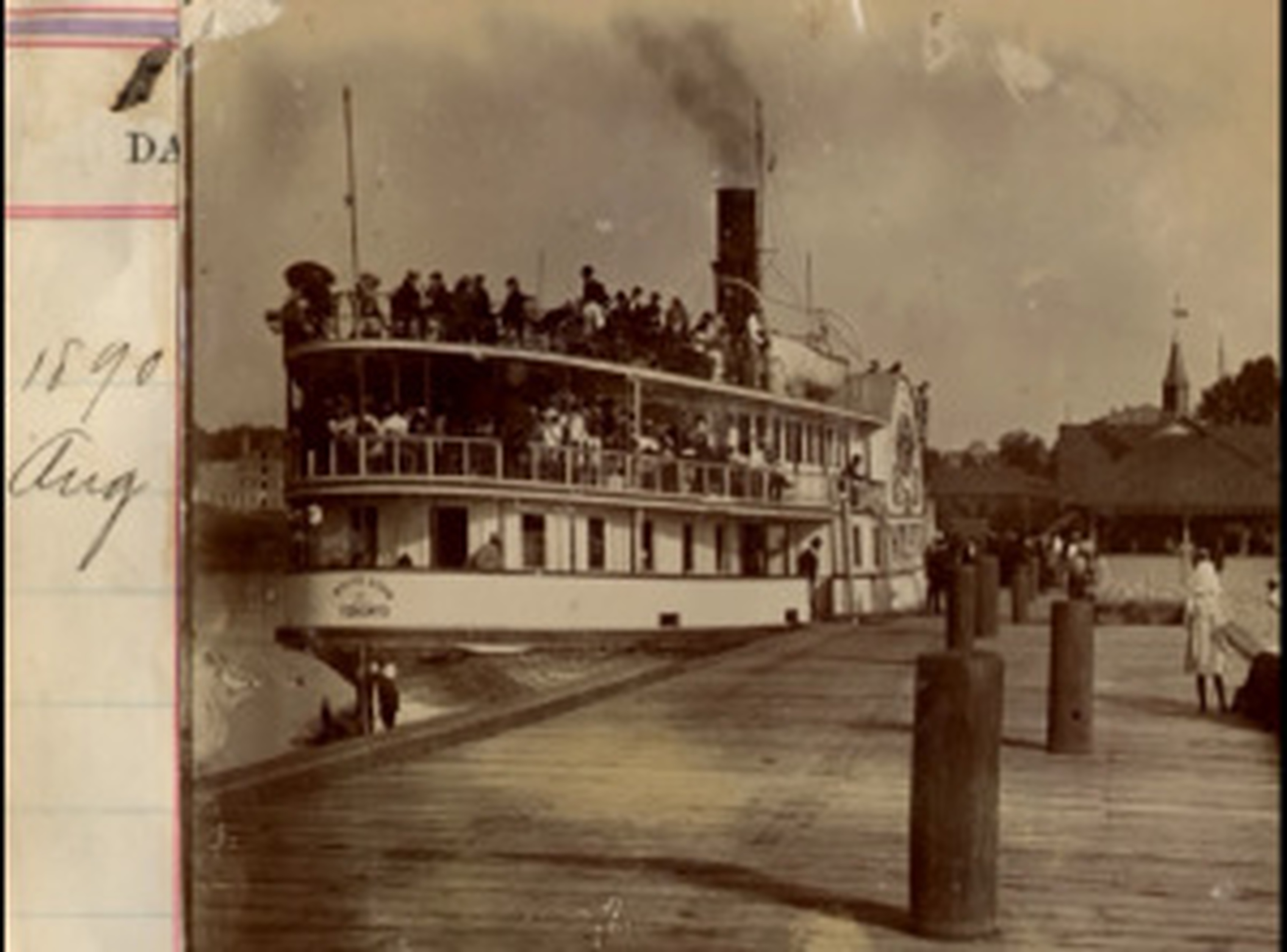 Old boat photo in black and white docked at a pier